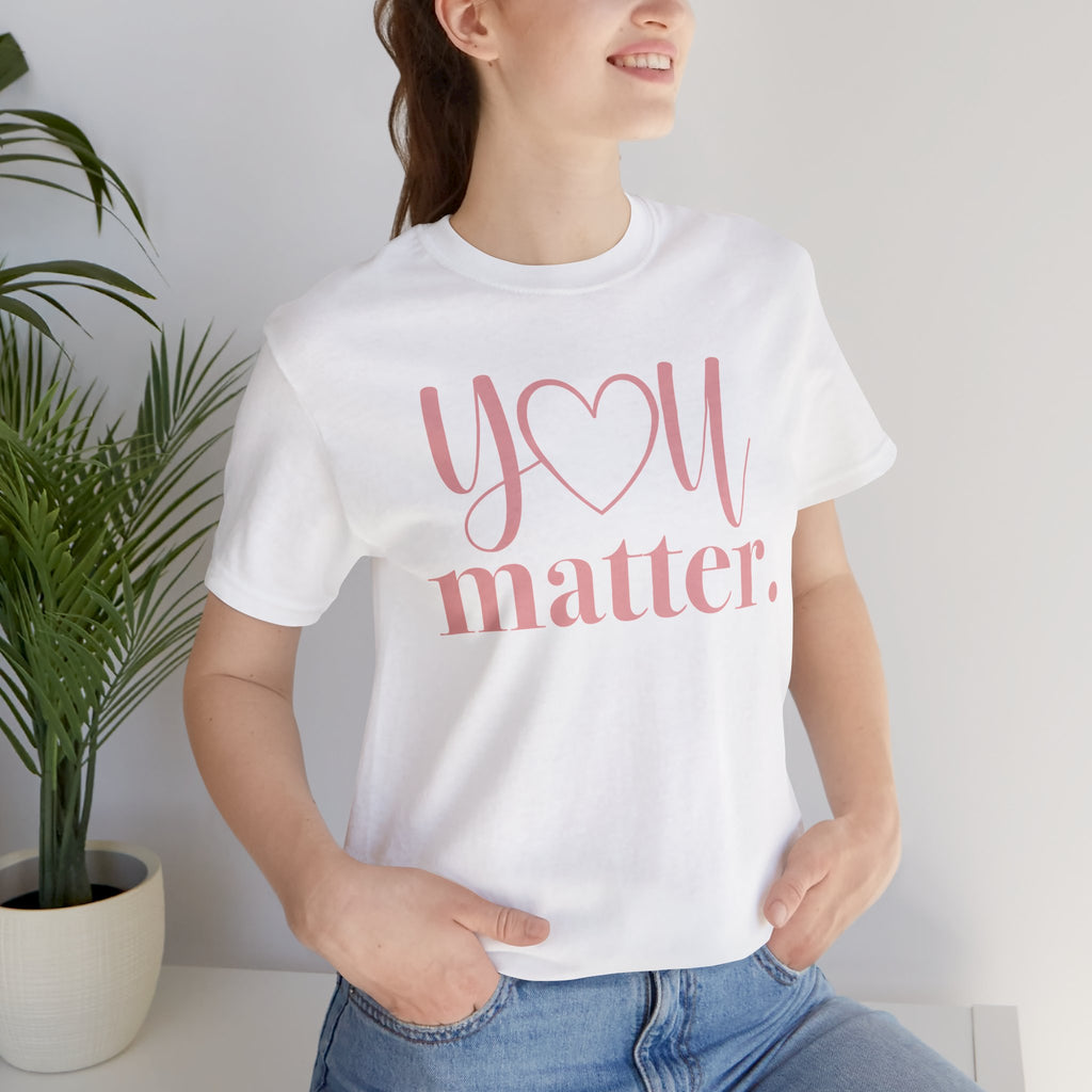 Person wearing a white t-shirt with 'You matter' text