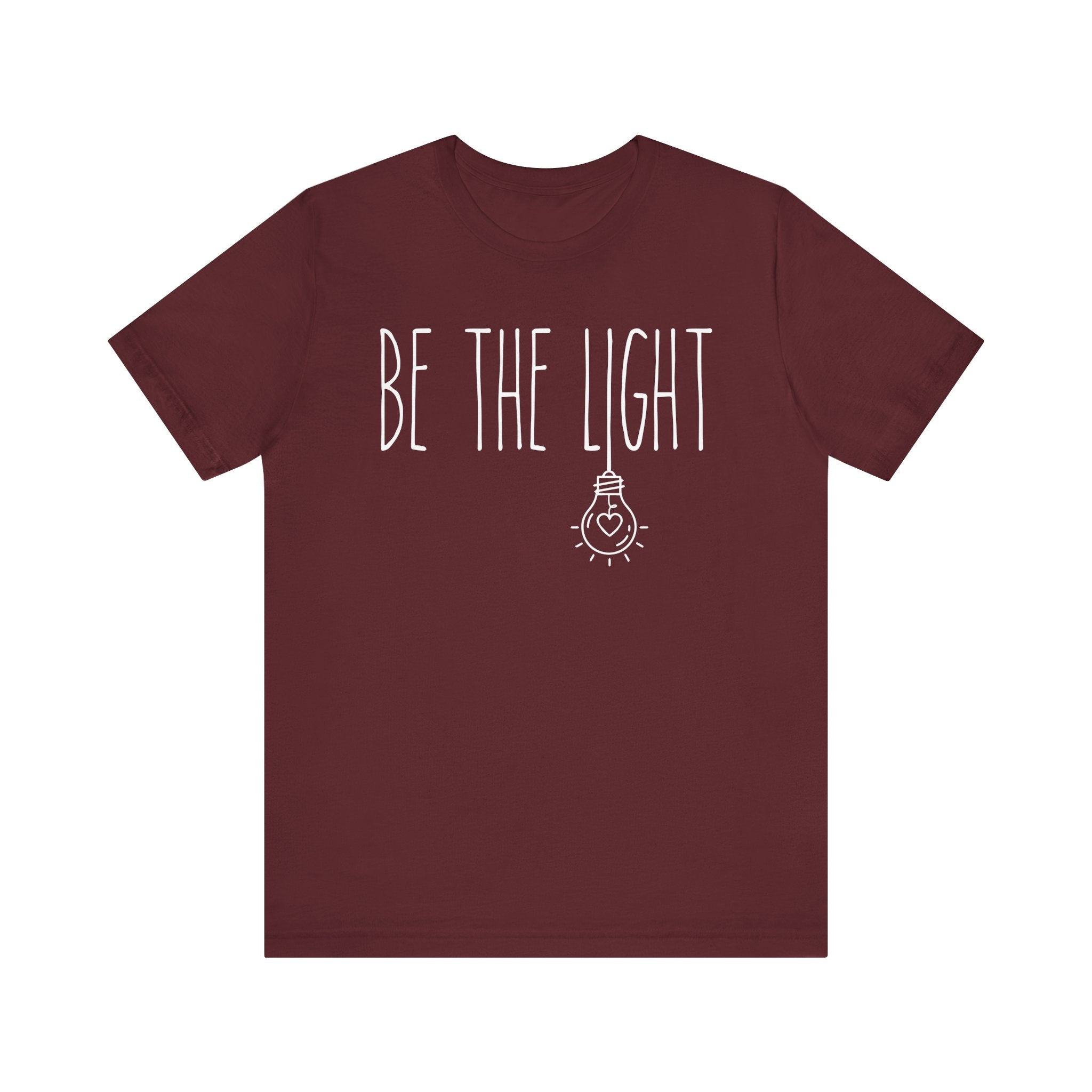Maroon t-shirt with 'BE THE LIGHT' text 