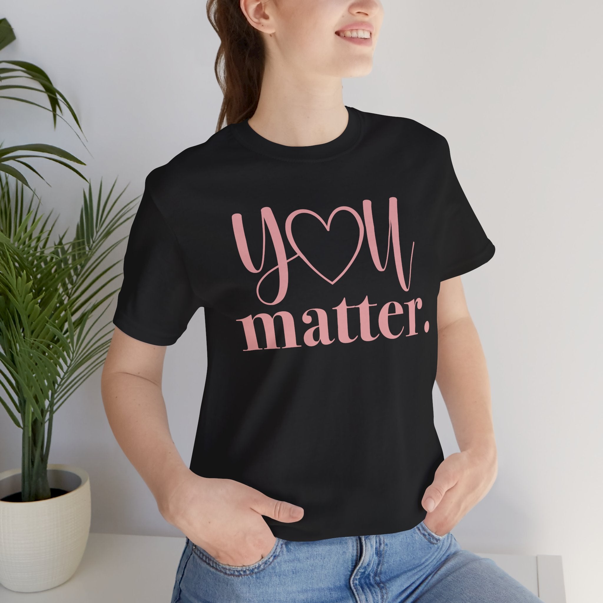 Person wearing a black t-shirt with 'You matter' text